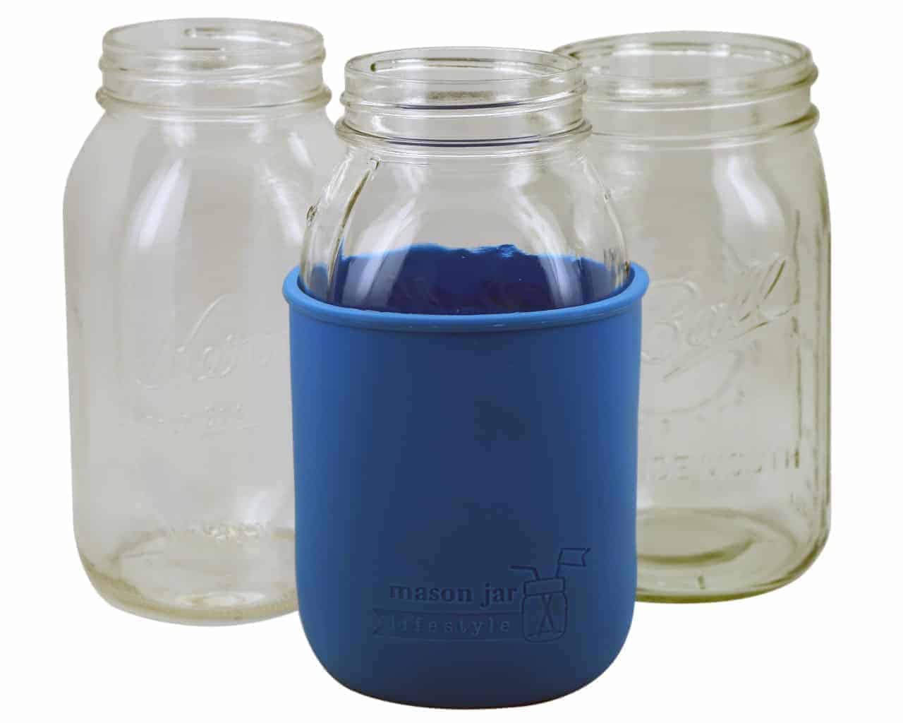 Clear glass jars with blue silicone sleeves on a white background
