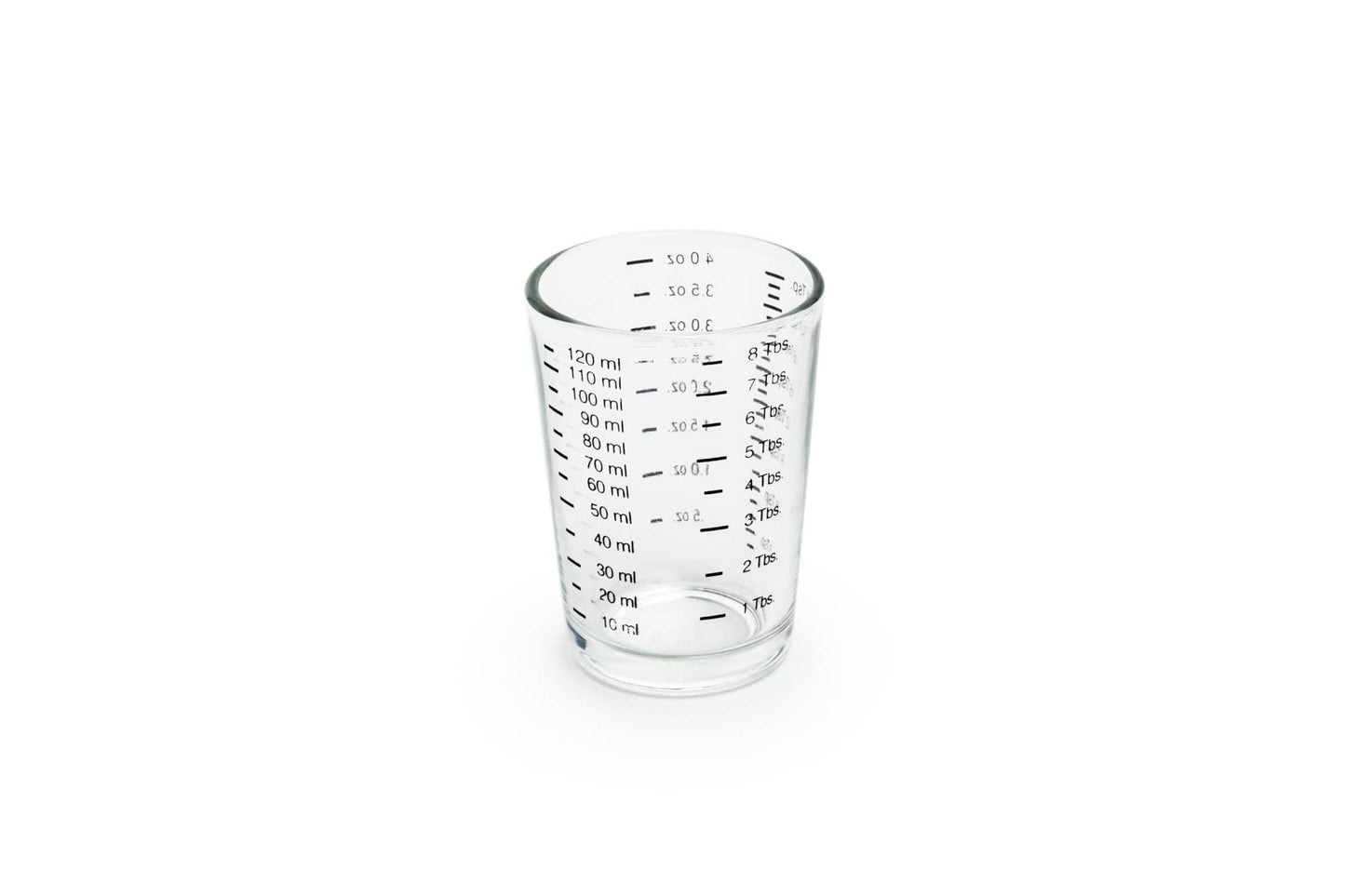 Clear glass measuring cup with measurements on a white background