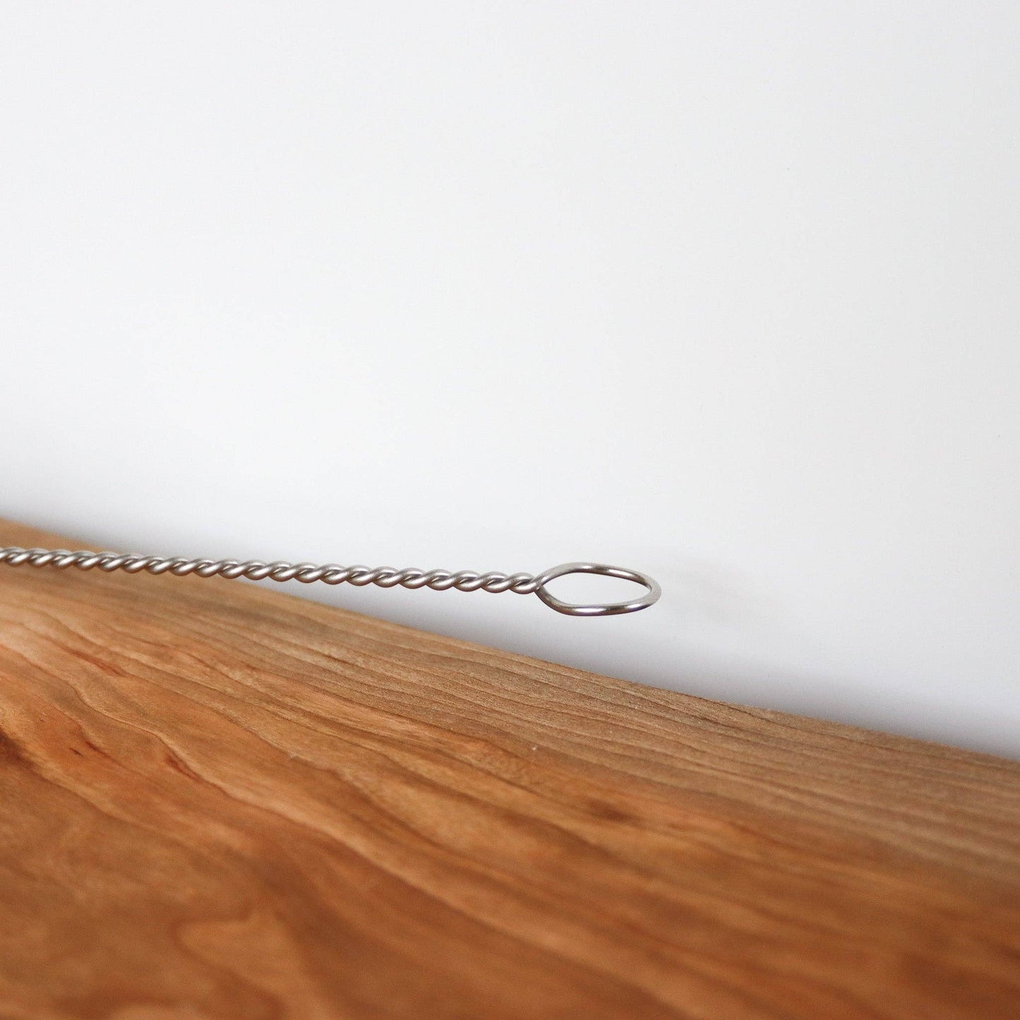 Wooden surface with a metal chain on a white background
