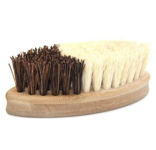 Double-sided brush with brown and white bristles on a wooden handle against a white background