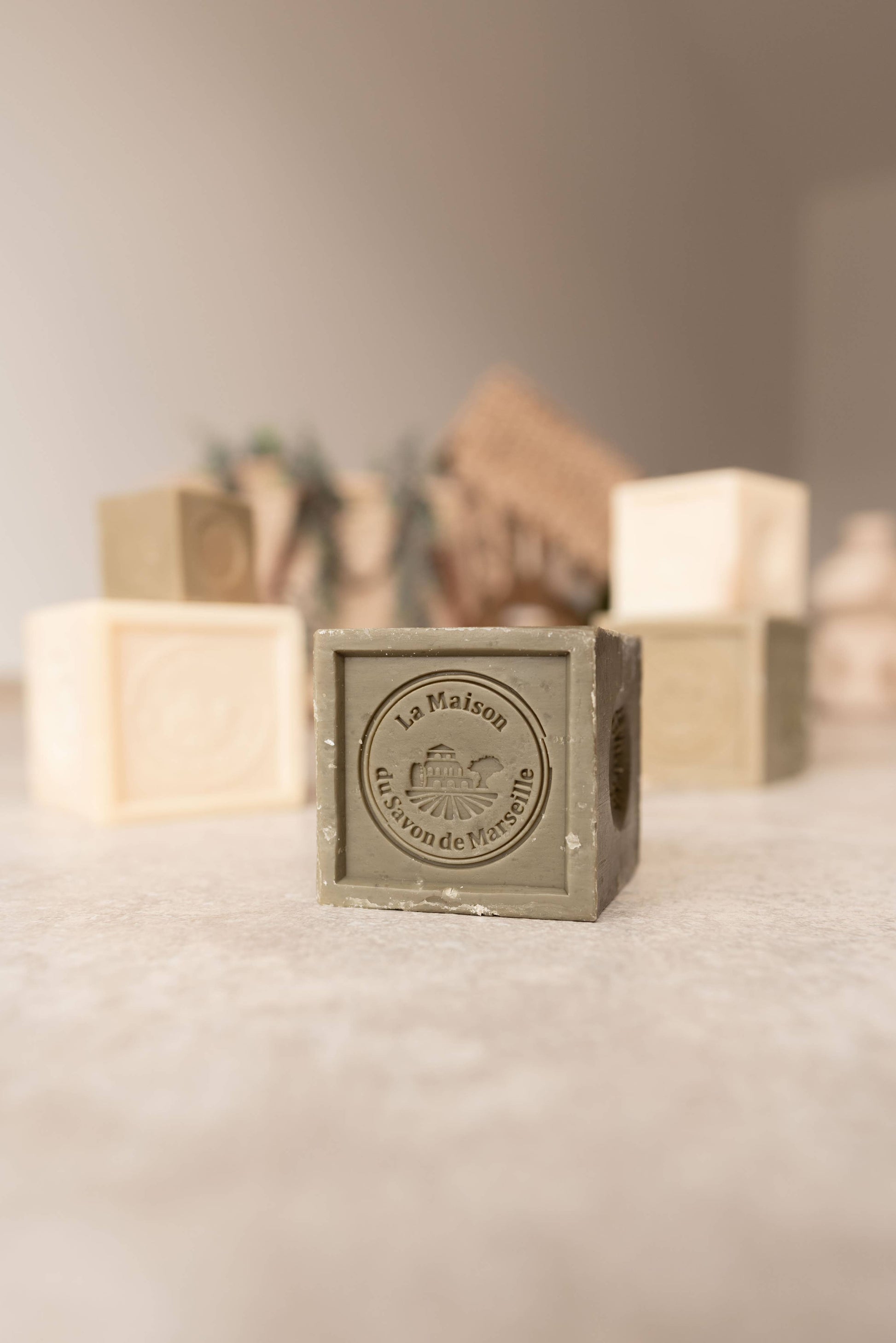 Square soap bar with 'La Marmite' branding on a textured surface.