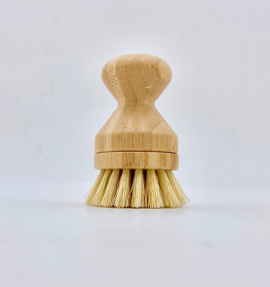 Bamboo dish brush with bristle head on a light gray background