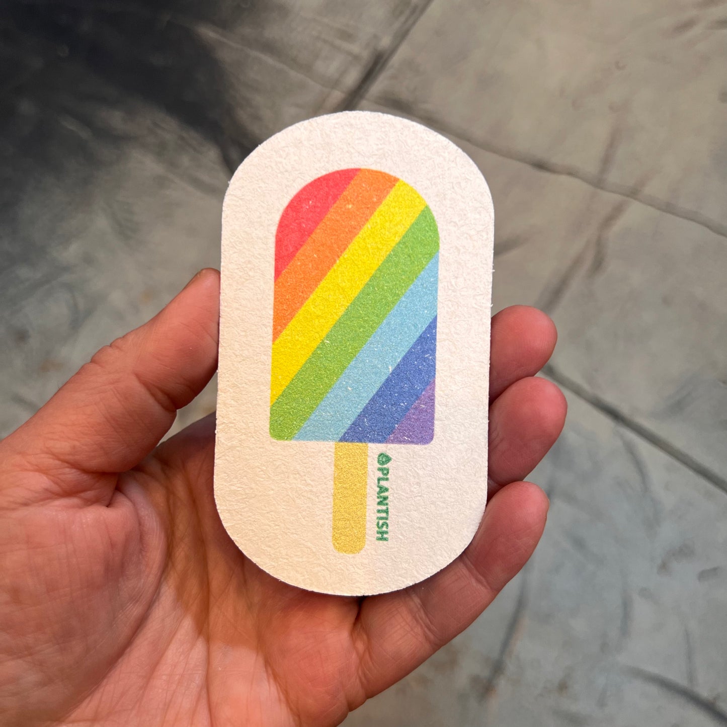 hand holding sponge: rainbow popsicle pattern