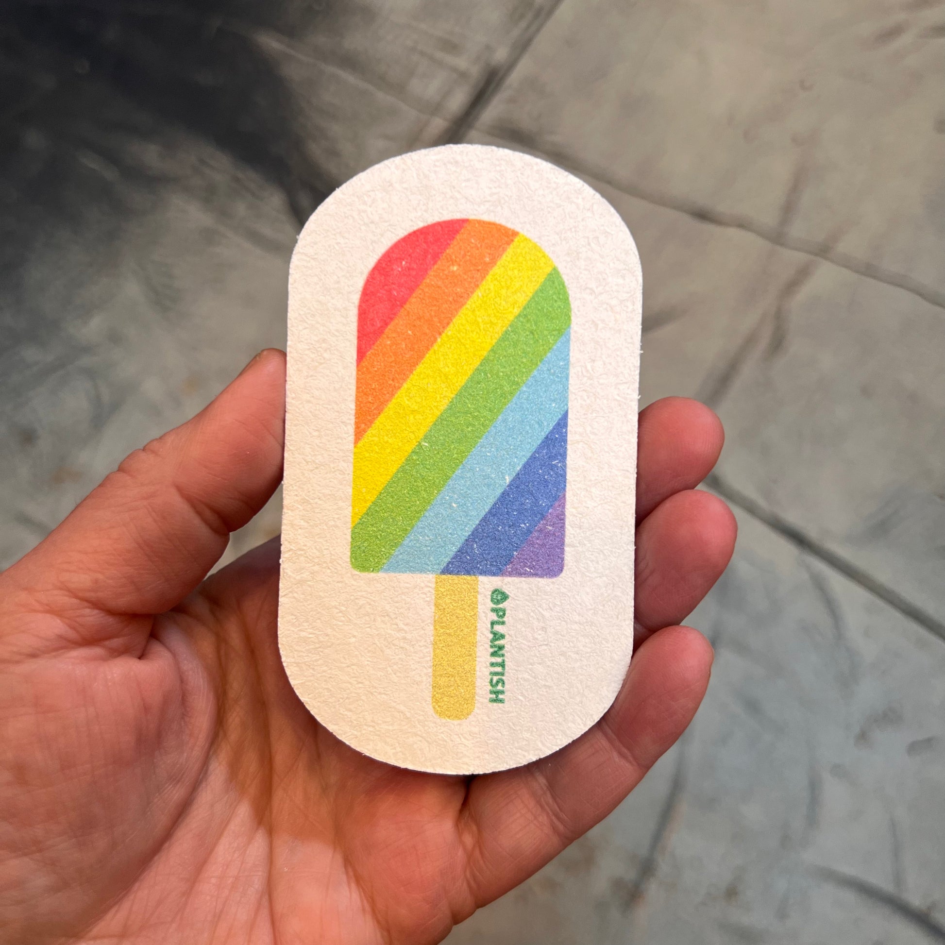 hand holding sponge: rainbow popsicle pattern