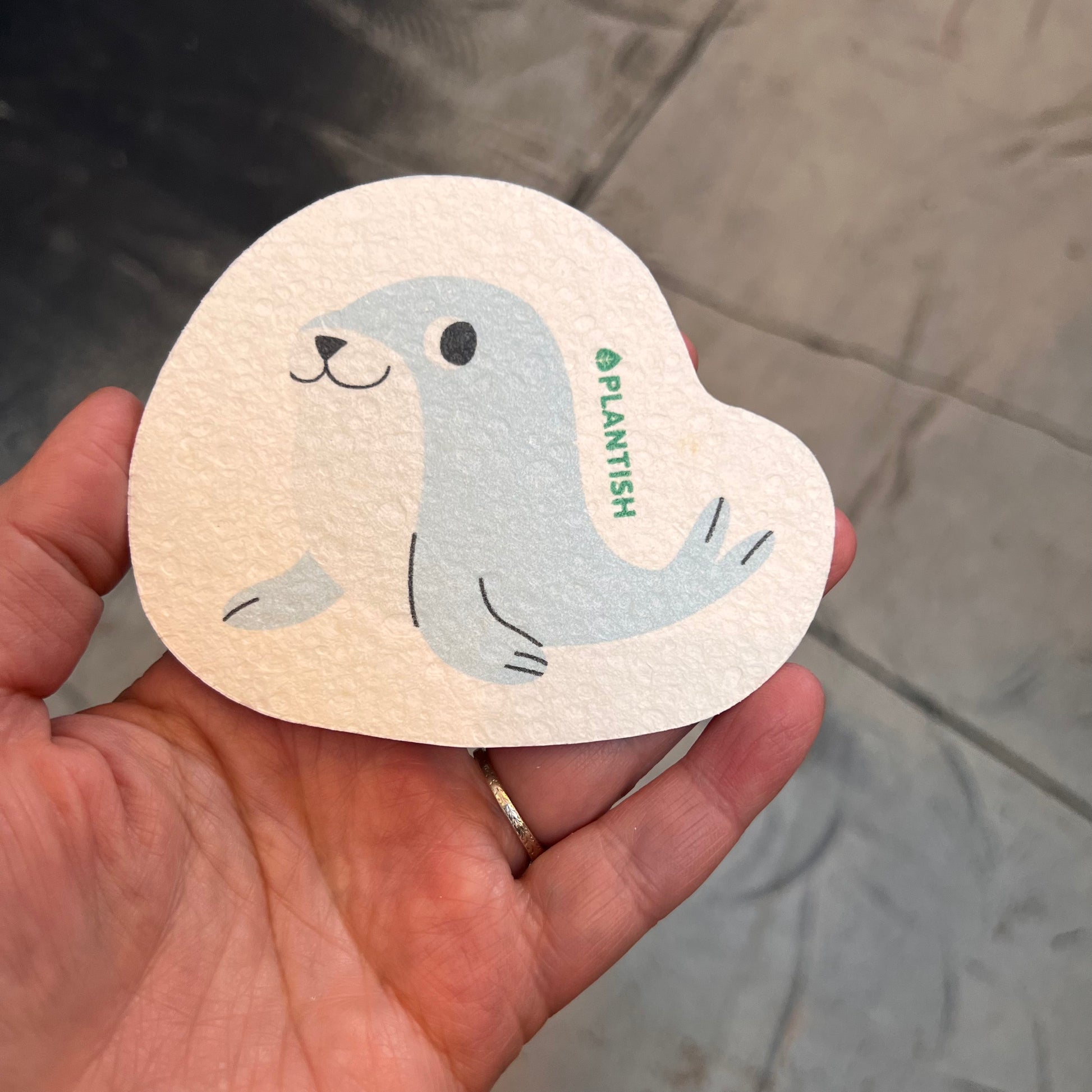 hand holding sponge: seal pattern