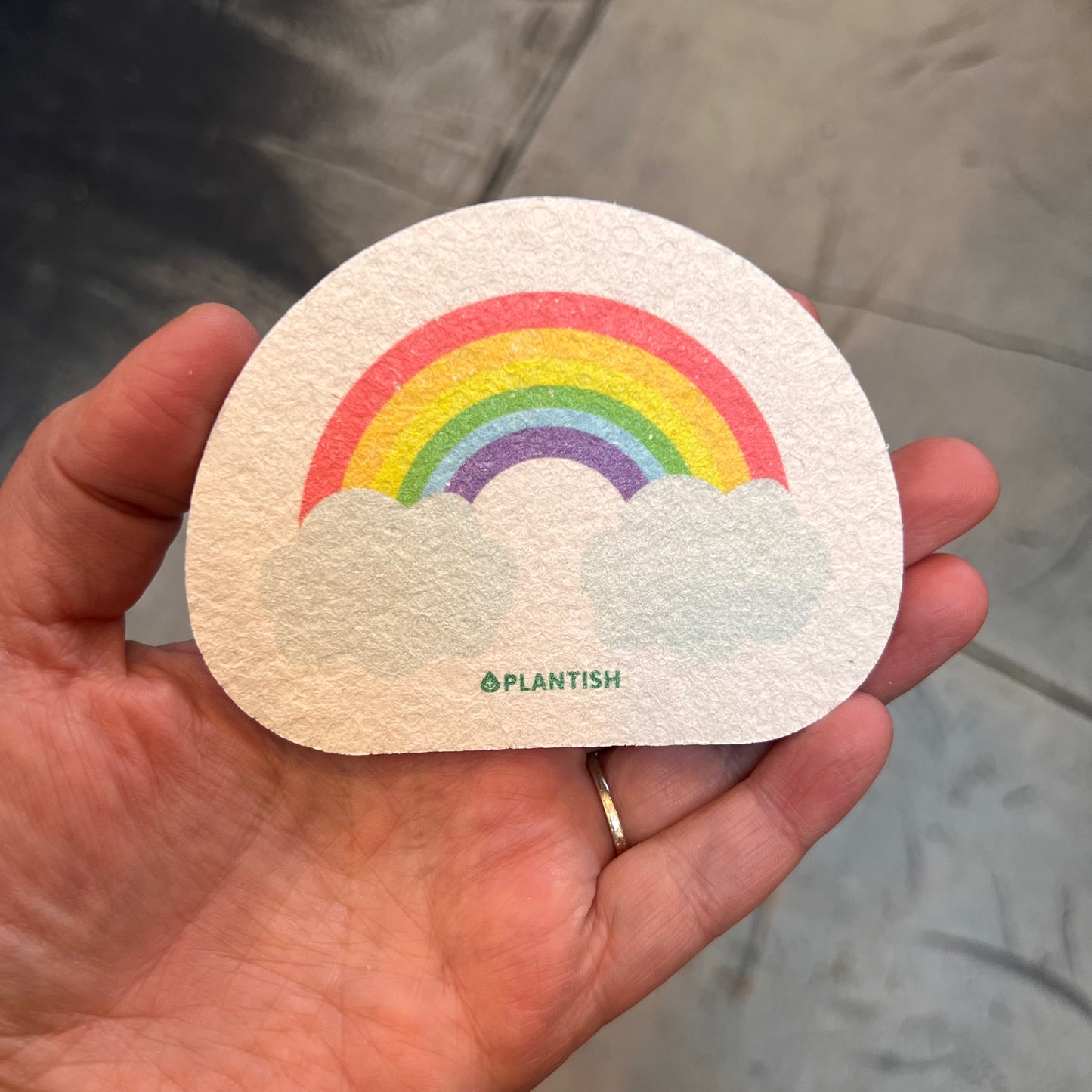 hand holding sponge: rainbow pattern