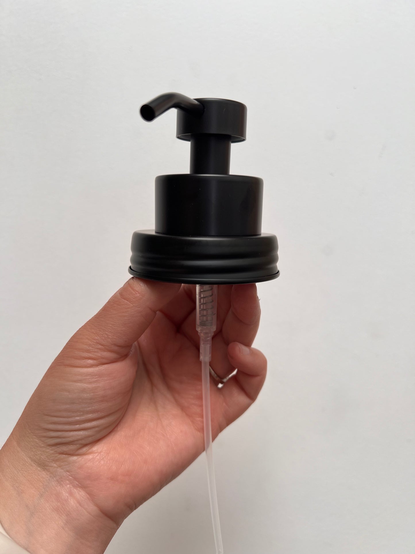 Hand holding foaming top black finish
