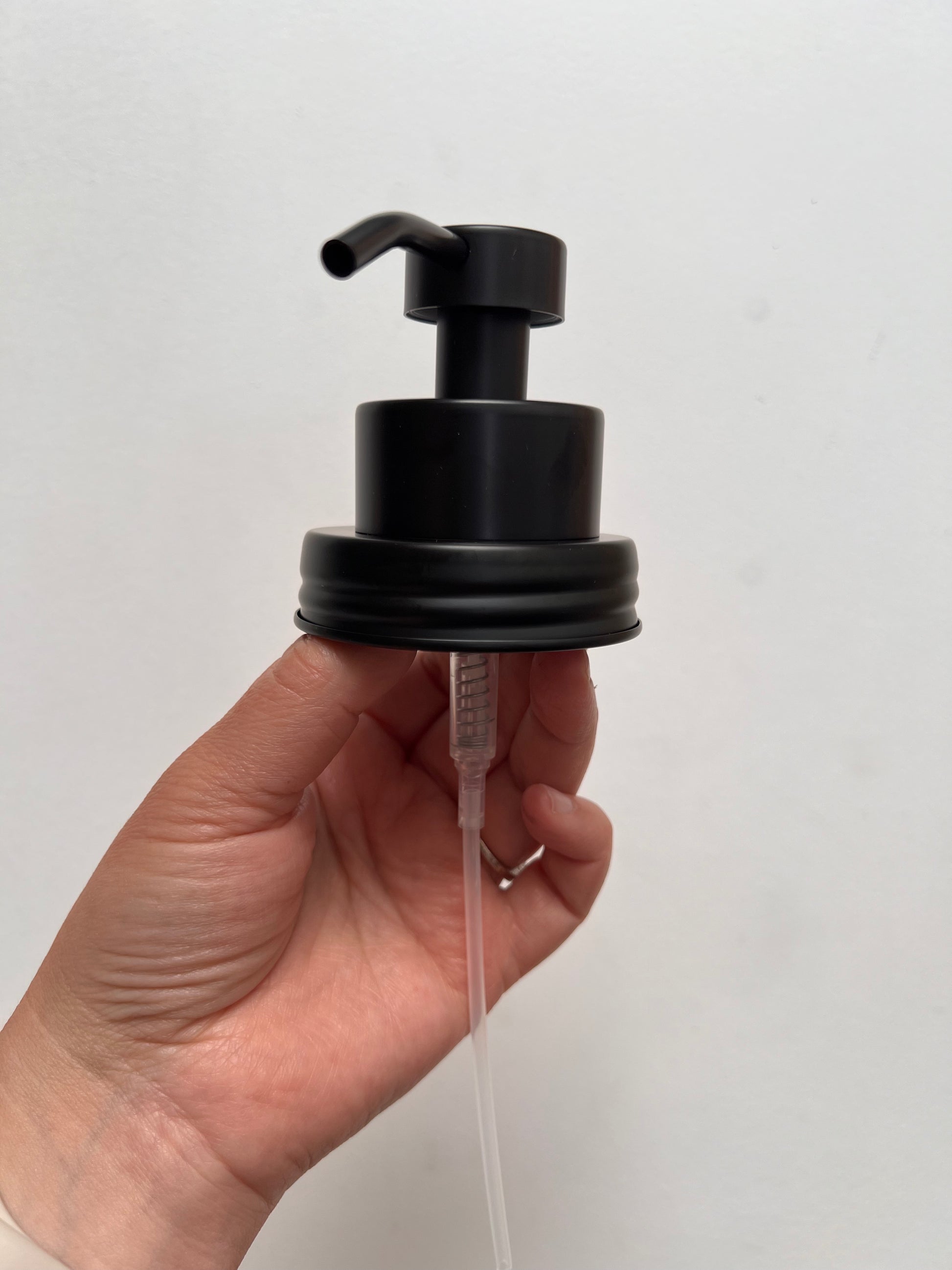 Hand holding foaming top black finish