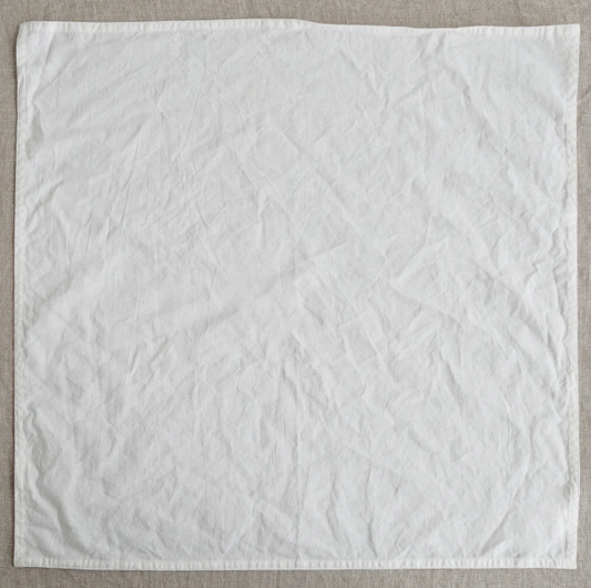 White textured fabric on a beige background