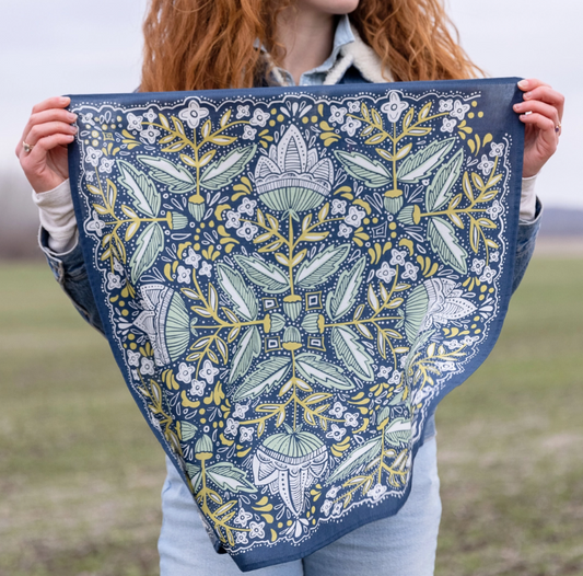 Person holding a floral patterned fabric in an outdoor setting