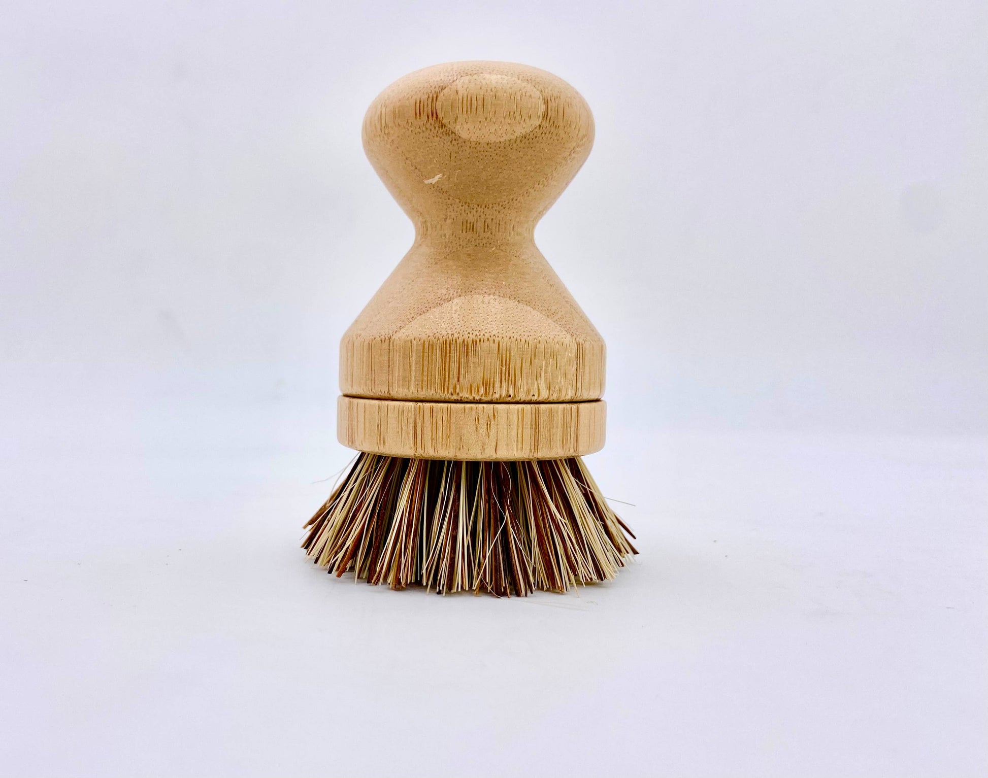 Wooden dish brush with bristle head on a white background