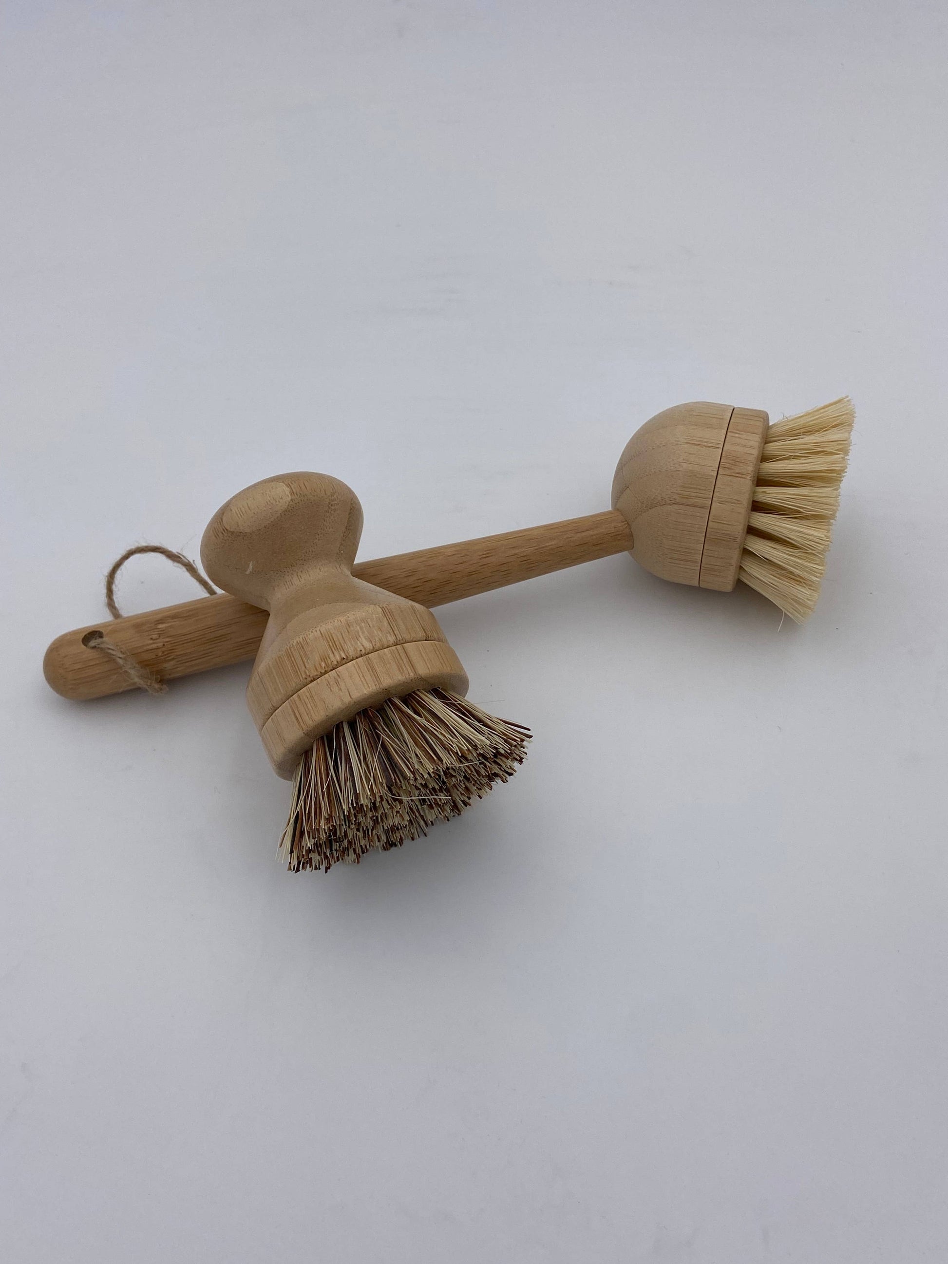Two wooden brushes with bristle heads on a white background
