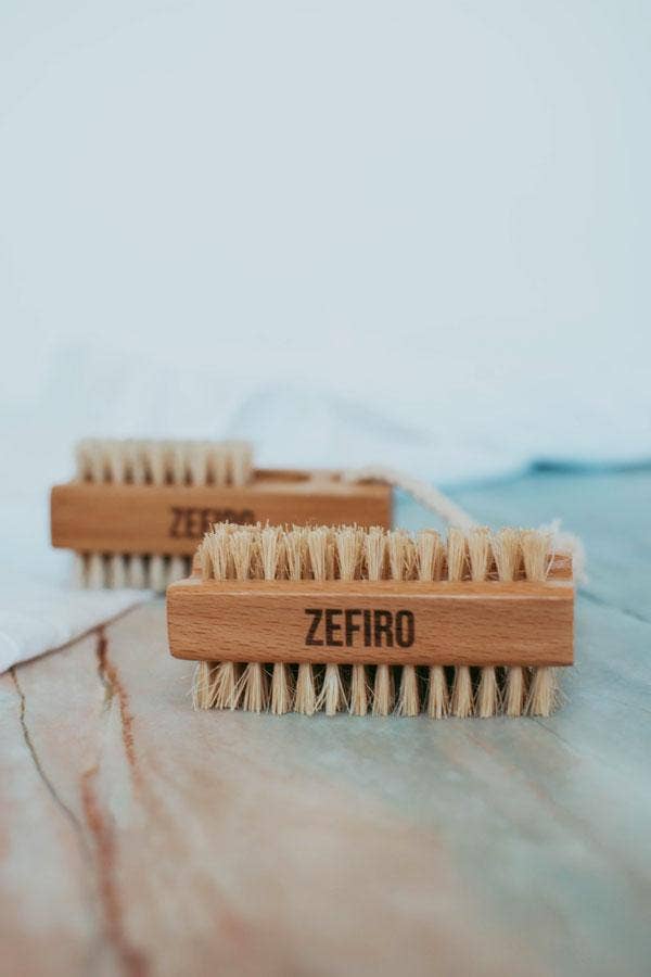 Two wooden brushes with bristles on a marble surface, branded 'Zefiro'.