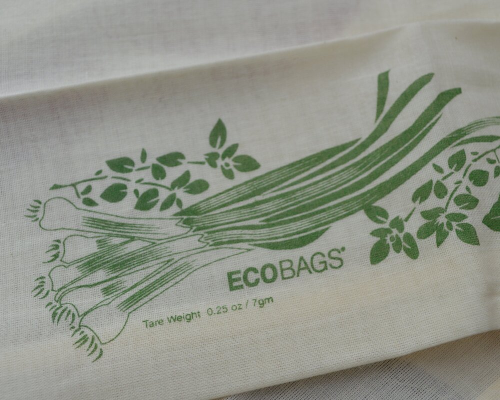 Close up of the cotton bag showing the tare weight of the bag and the printed veggies.