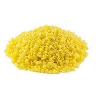 Yellow beeswax pellets to show texture