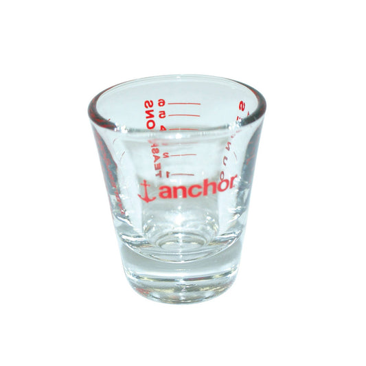 Clear measuring glass with red text and 'anchor' branding on a white background