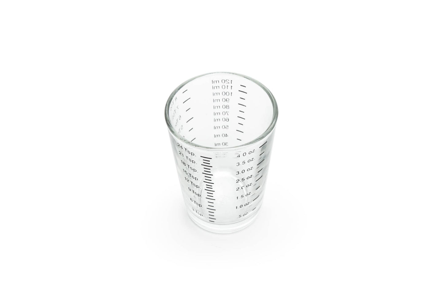 Clear glass measuring cup with measurement markings on a white background