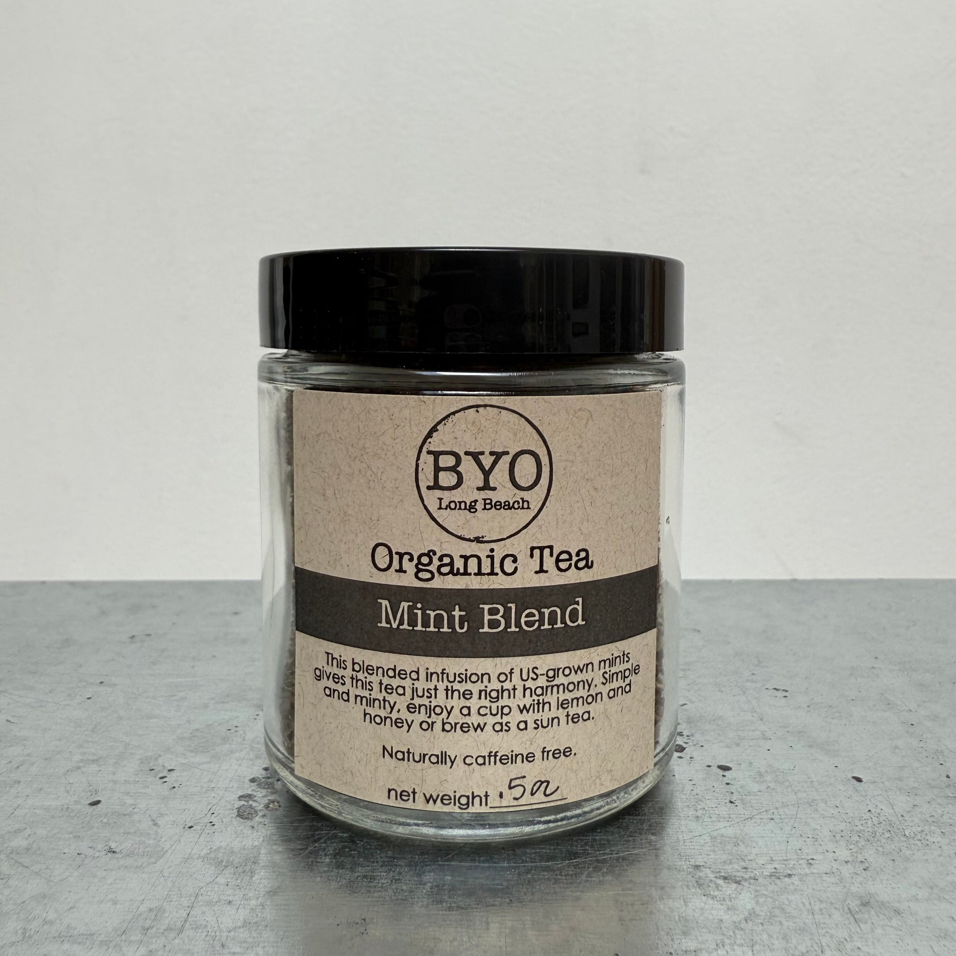 Jar of Organic Tea Mint Blend by BYO on a gray surface with a white background