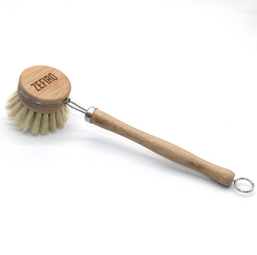Dishwashing brush with wooden handle and bristle head on a white background