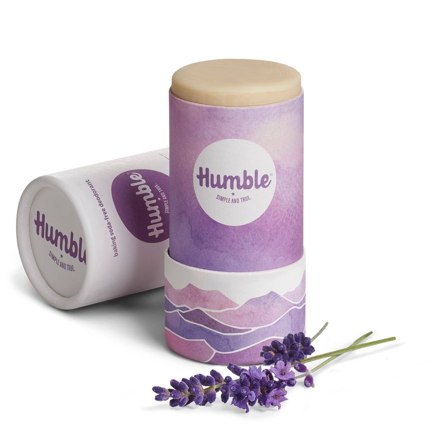 Two 'humble' branded lip balm containers with a sprig of lavender on a white background