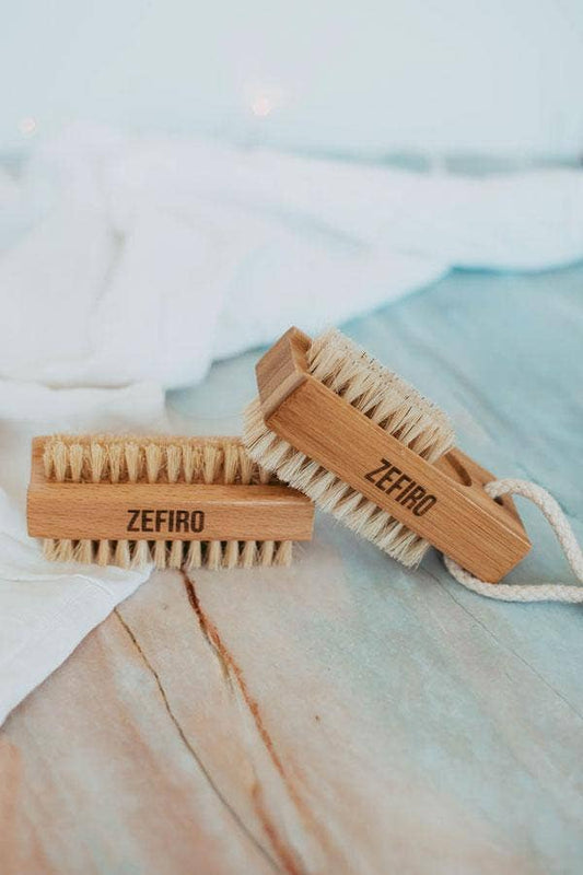 Two wooden brushes with bristles on a textured surface
