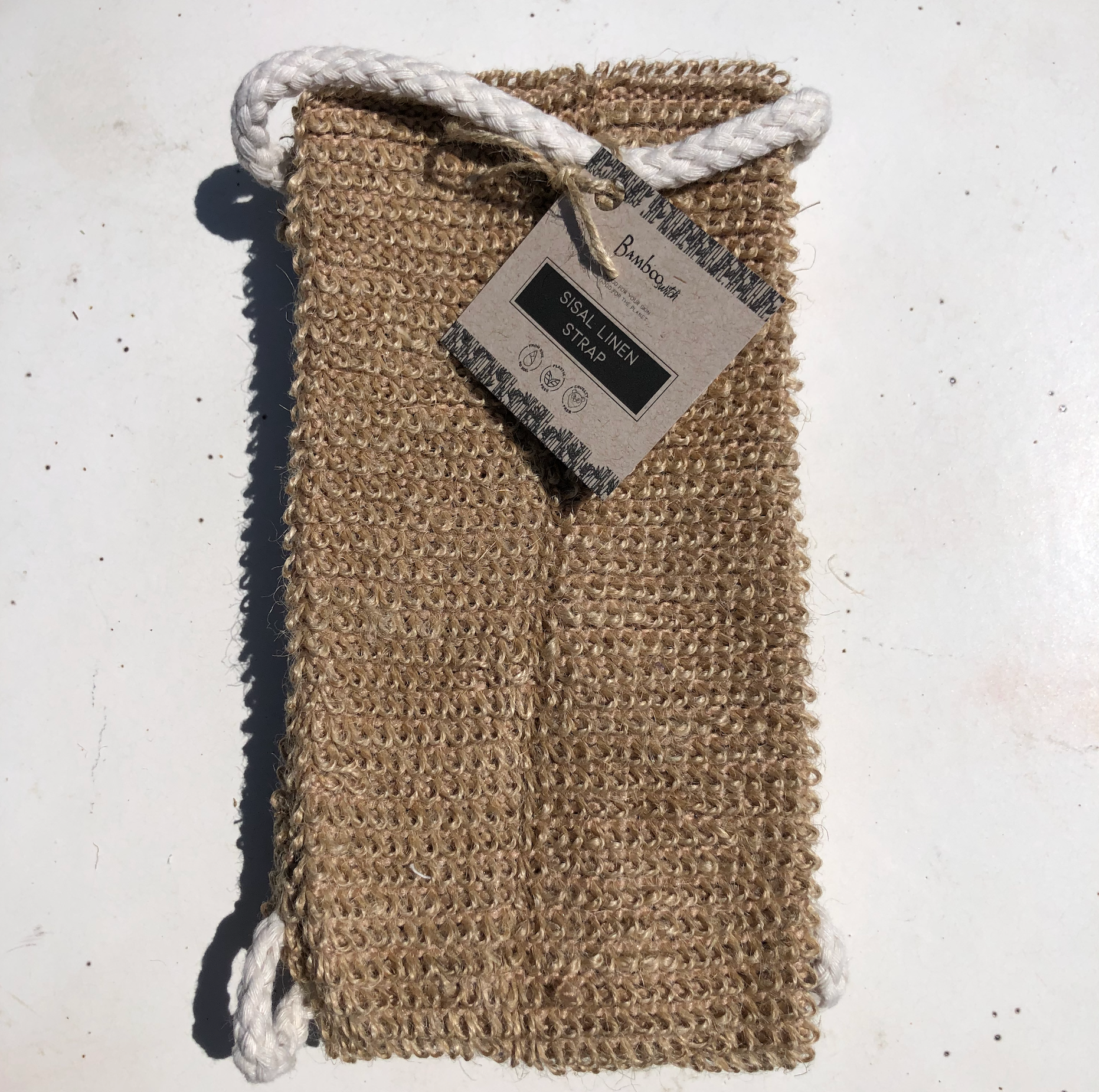 Textured soap bag with rope handle on a white background