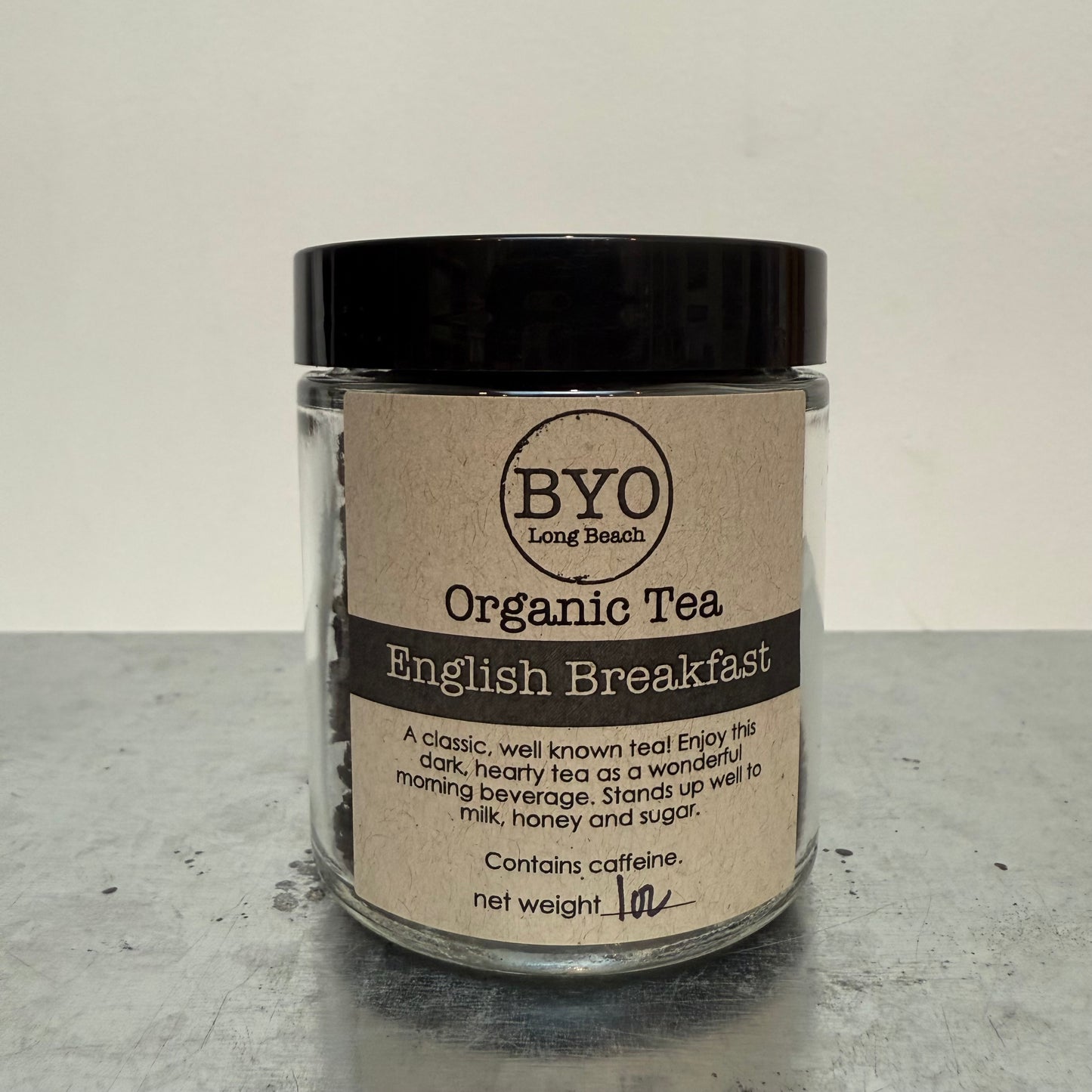 Jar of Organic Tea with 'BYO' label on a gray surface