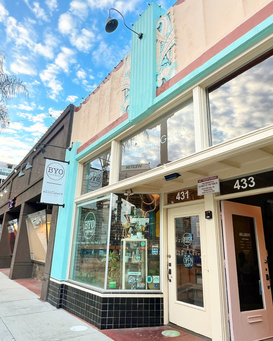 Commercial building with a sign for 'BYO' on a clear day
