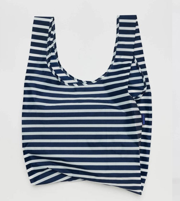 White background with nylon bag laying flat to show navy blue and white stripe pattern