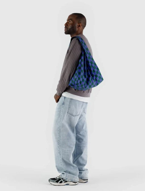 White background with man carrying standard size nylon bag on shoulder to show checkered blue and dark green pattern