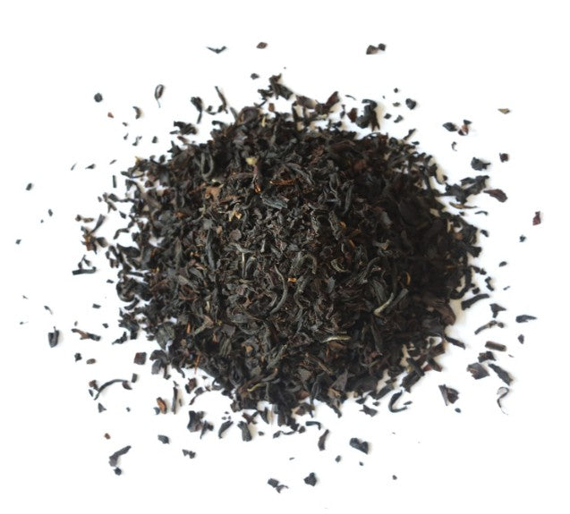 Dry black tea leaves on a white background