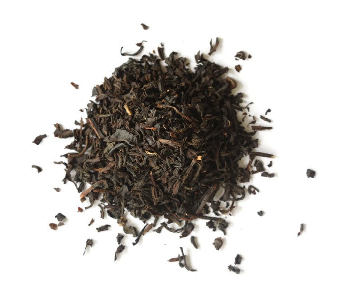 Dry black tea leaves on a white background