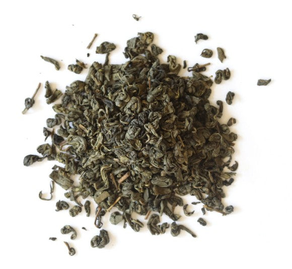 Dry green tea leaves on a white background