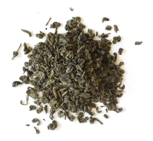 Dry green tea leaves on a white background