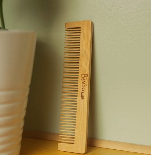 Bamboo comb leaning against wall