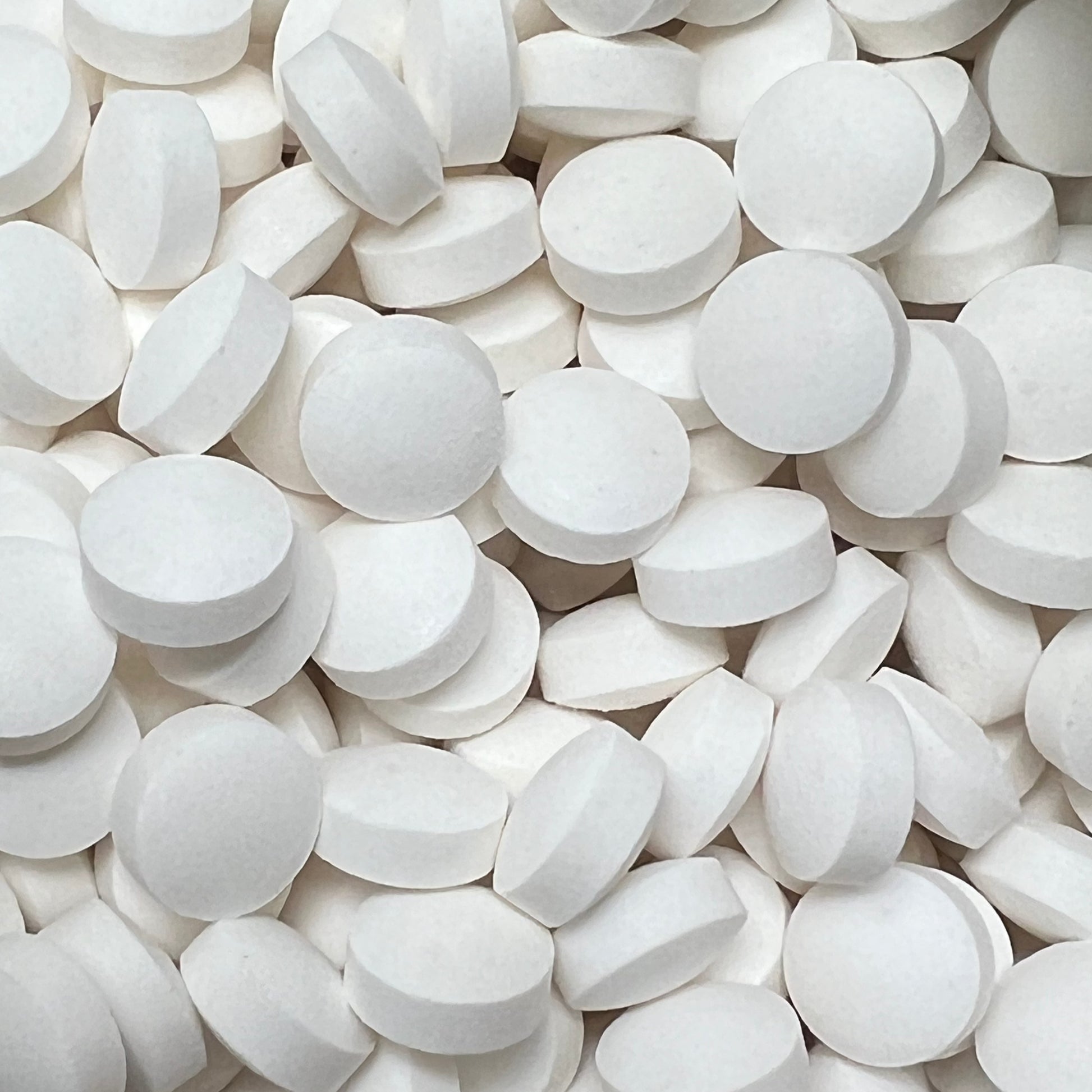 close up showing toothpaste tablets, white disk shape