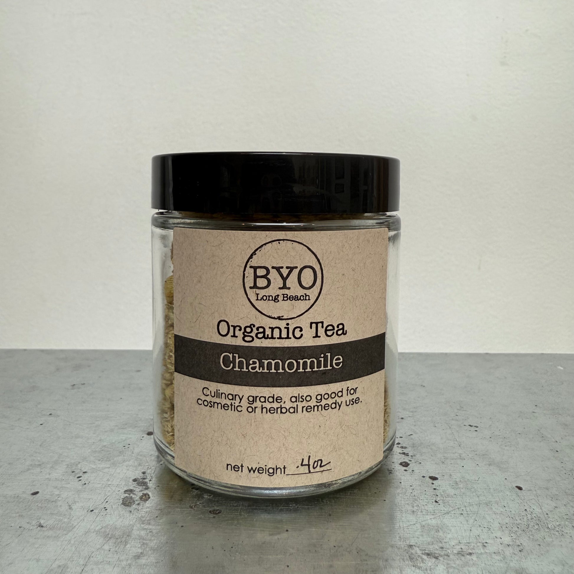 Jar of BYO Organic Tea Chamomile on a gray surface with a white background