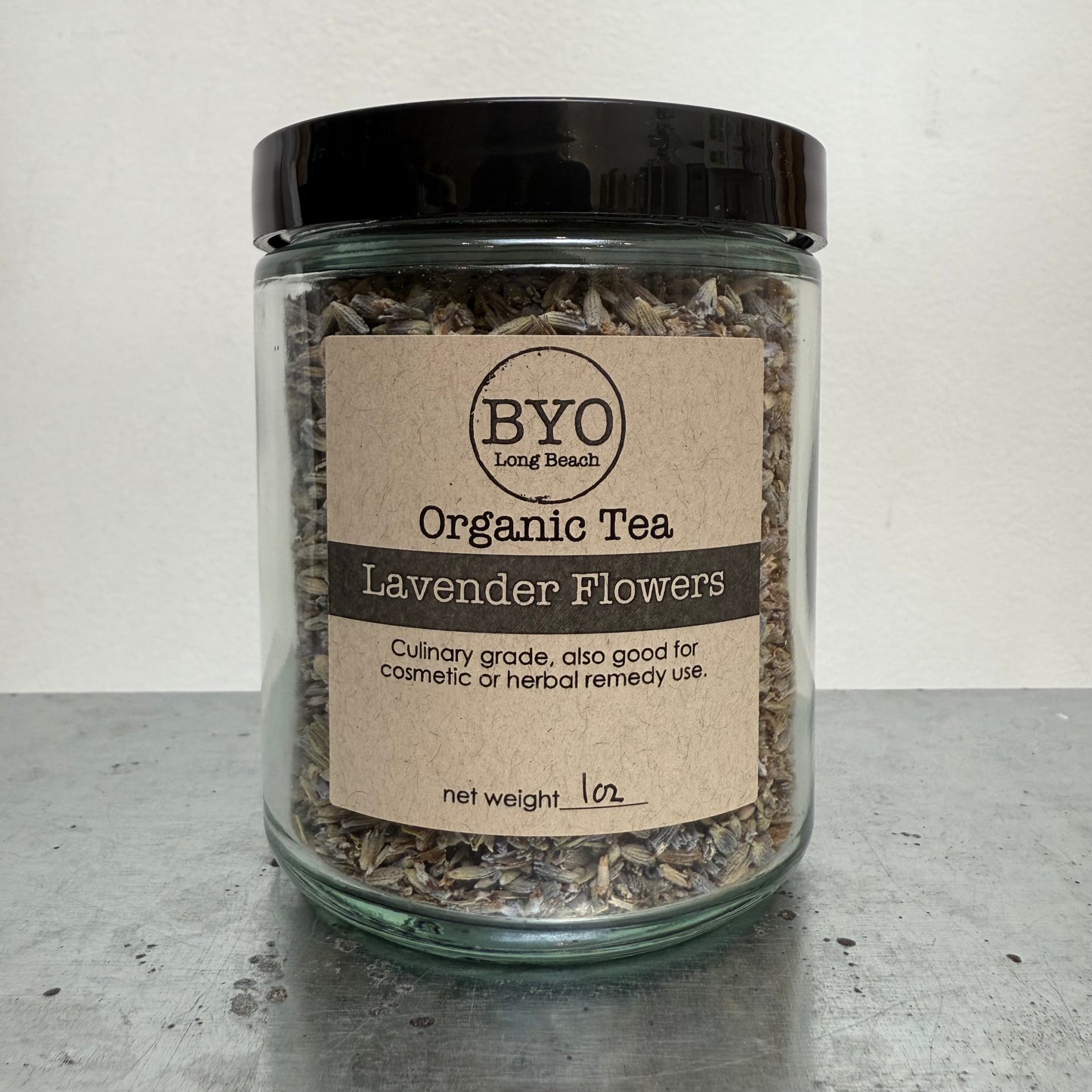 Jar of organic lavender flowers tea with a label on a gray surface