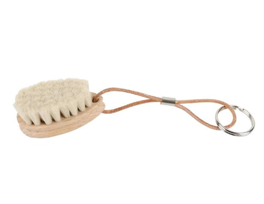 Small wood brush with natural bristles on a keychain.