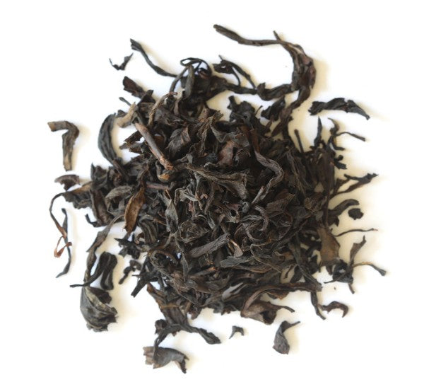 Dry black tea leaves on a white background