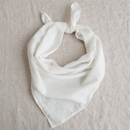White scarf on a beige textured fabric background