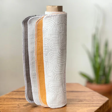 Roll of cloth towels on a wooden surface