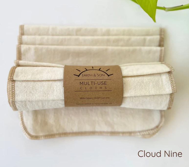 Set of multi-use cloths with a branded label on a white background