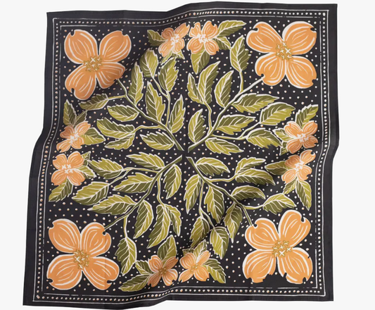 Floral patterned fabric with orange flowers and green leaves on a black background