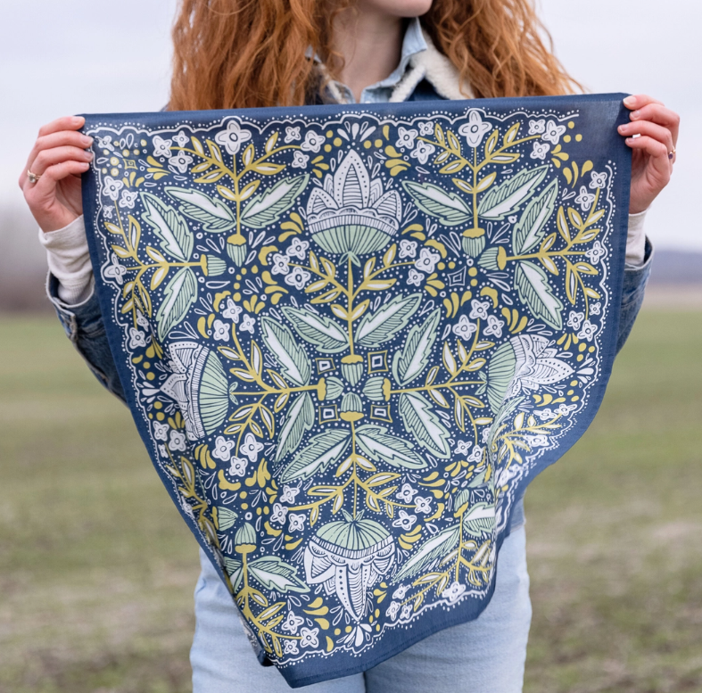 Person holding a floral patterned fabric in an outdoor setting