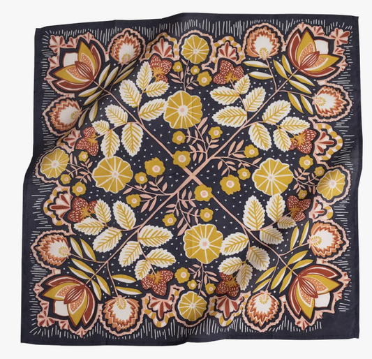 Floral patterned fabric with yellow, orange, and green flowers on a dark background