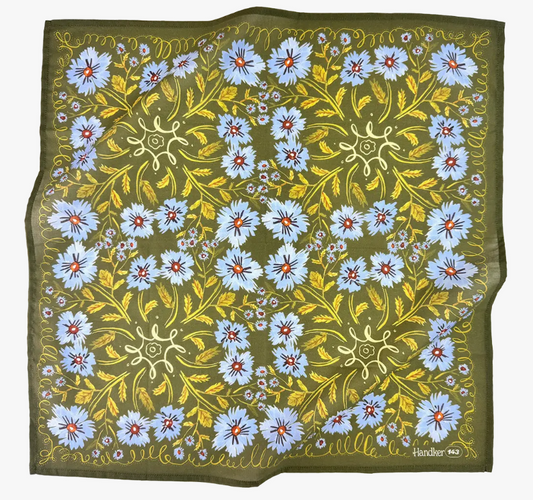Floral patterned fabric with blue flowers and green background