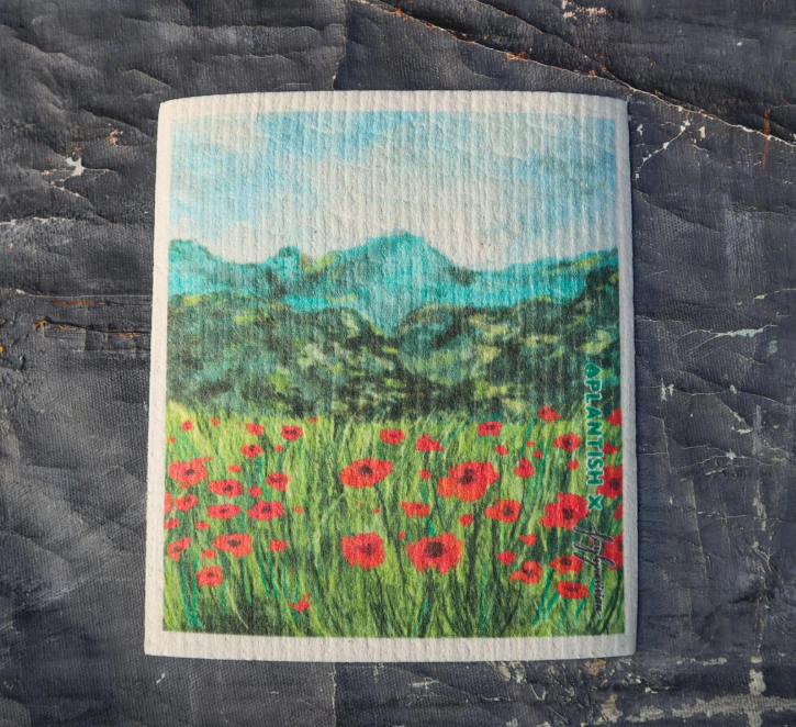 Painting of poppies with landscape background on a cleaning cloth