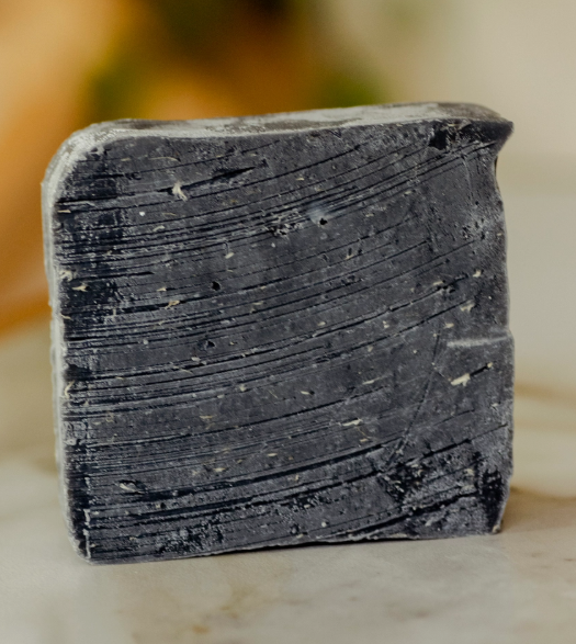 Rustic black bar soap shown for texture