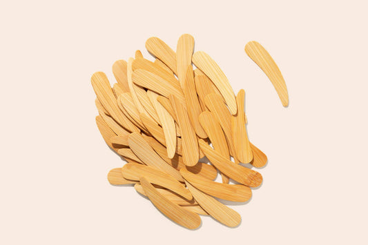 Pile of wooden sticks on a beige background